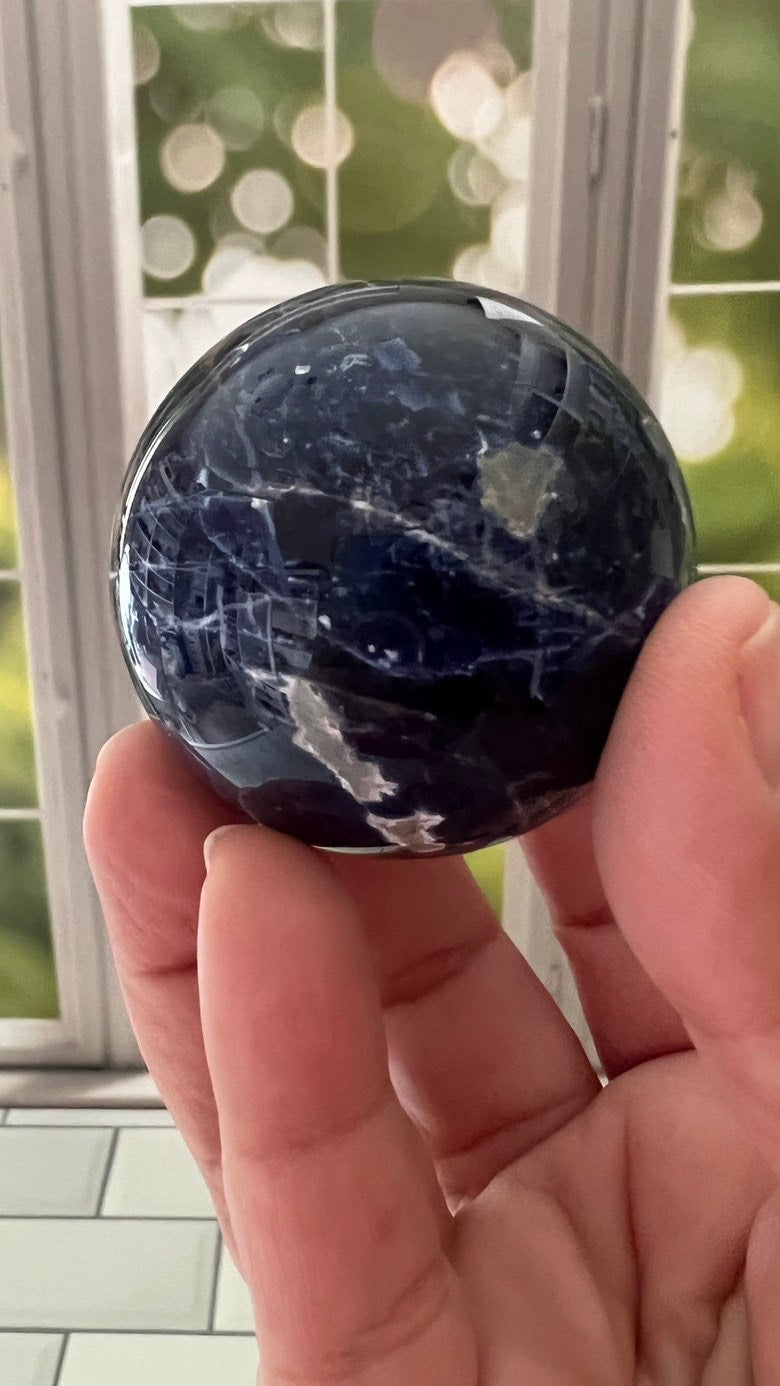 Stunning 2 inch Sodalite Sphere with deep royal blue color with a white calcite pattern, wooden stand included.
