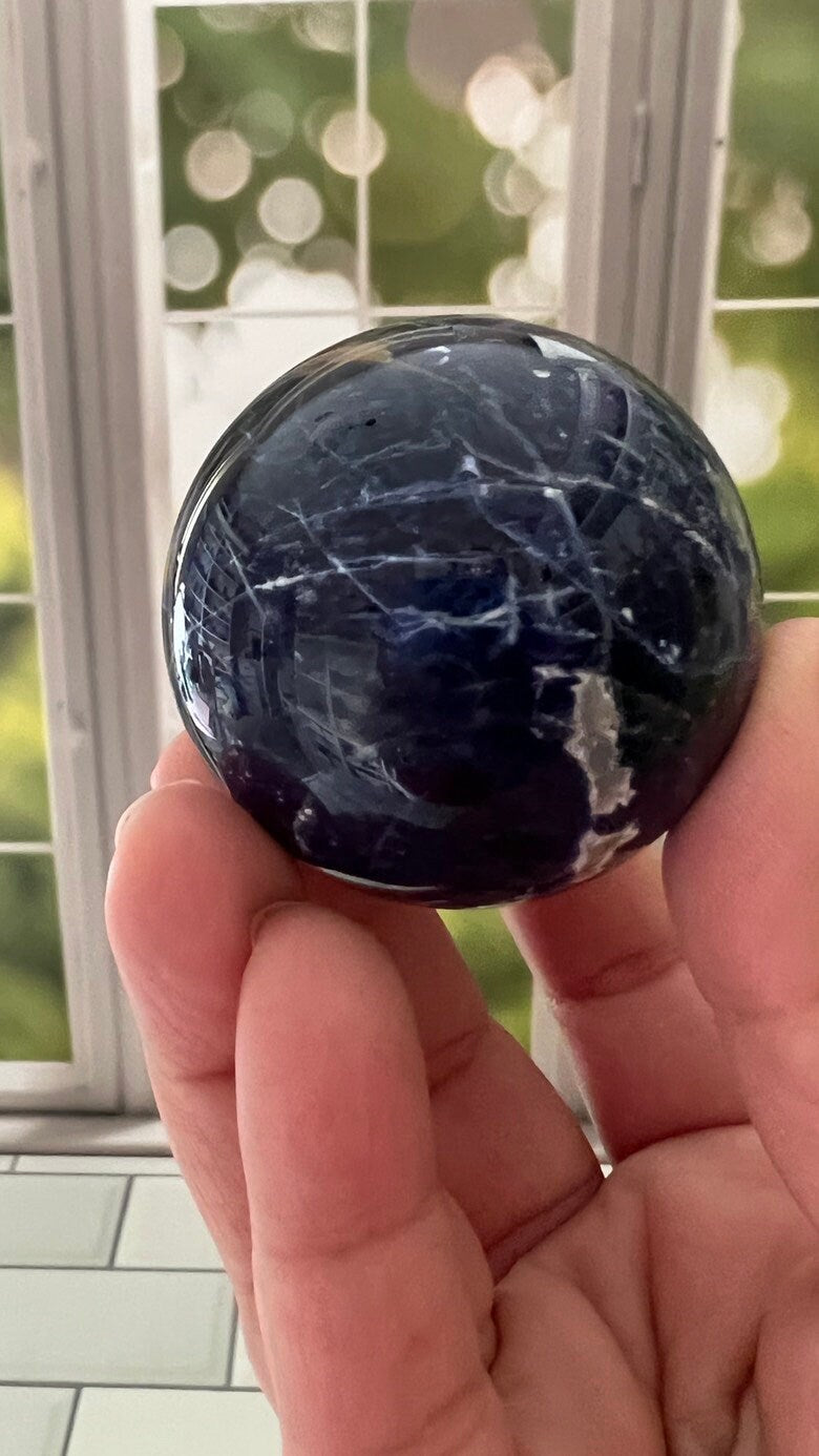 Stunning 2 inch Sodalite Sphere with deep royal blue color with a white calcite pattern, wooden stand included.