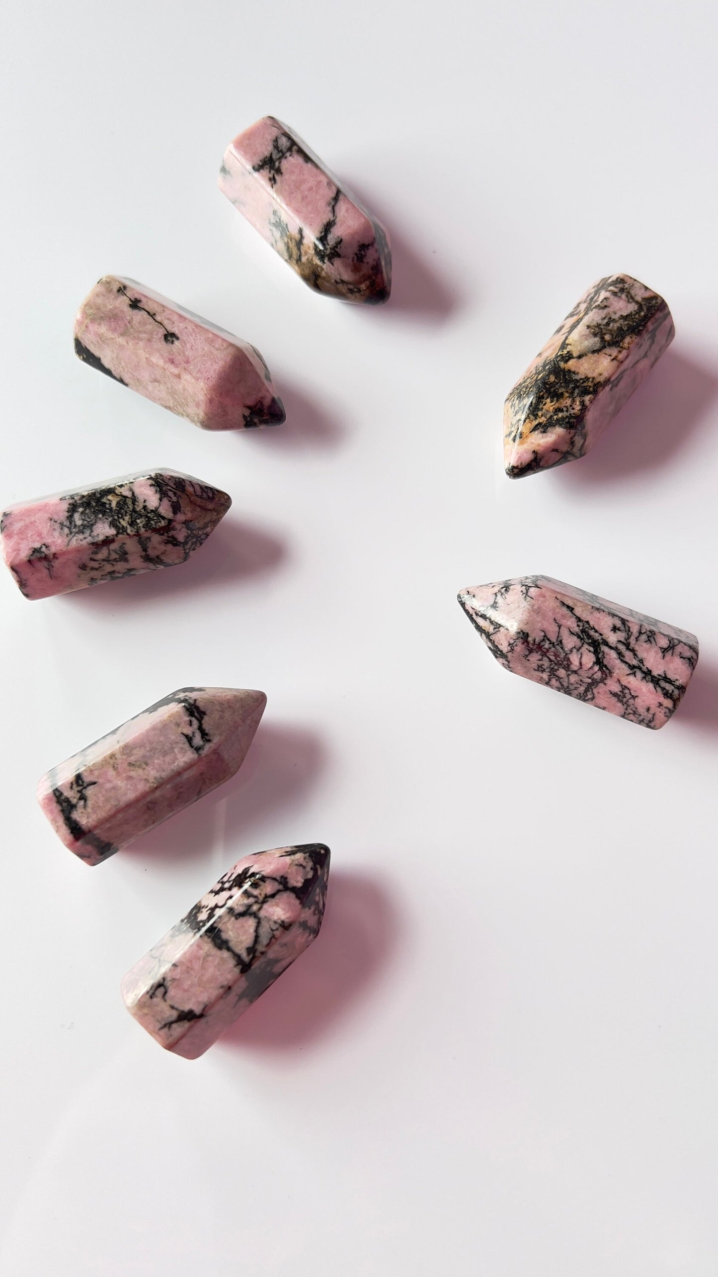 Colorful Rhodonite mini points 1 1/2 inch tall towers with a great pink color and black manganese throughout, Small and subtle crystals.