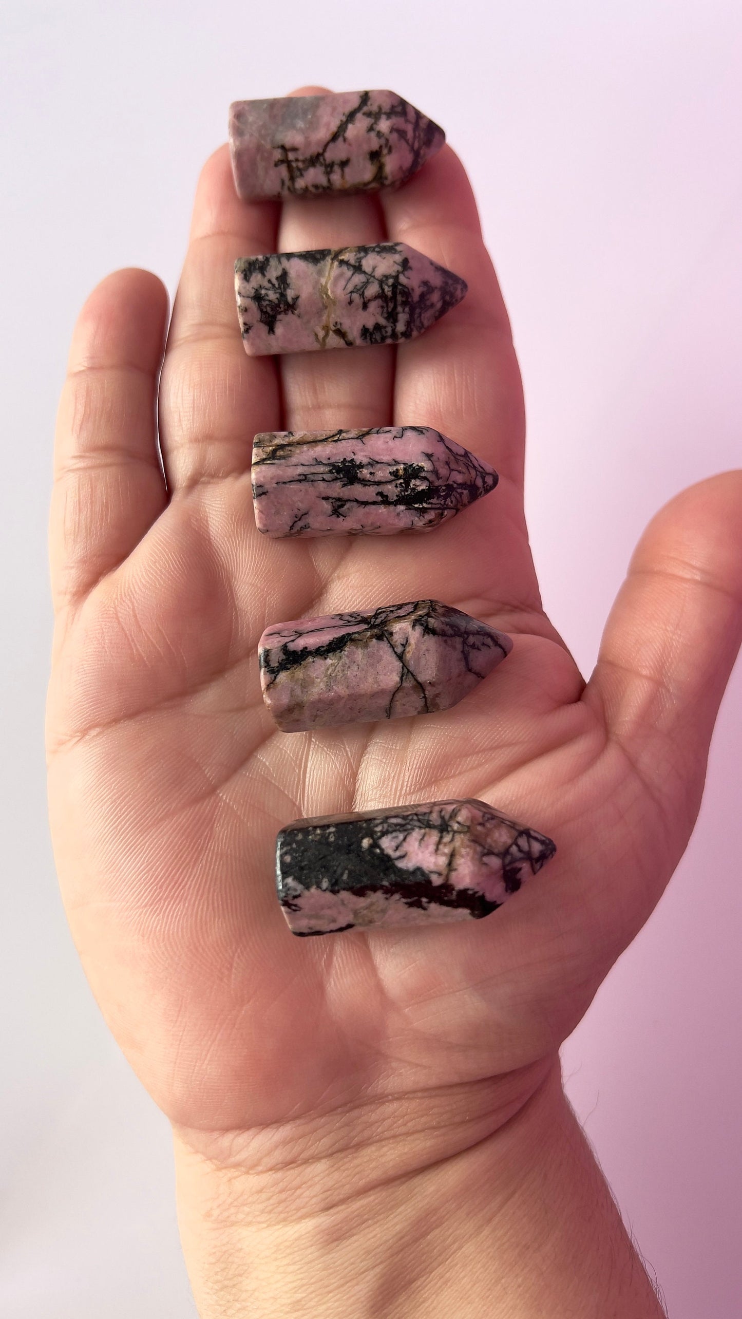 Colorful Rhodonite mini points 1 1/2 inch tall towers with a great pink color and black manganese throughout, Small and subtle crystals.