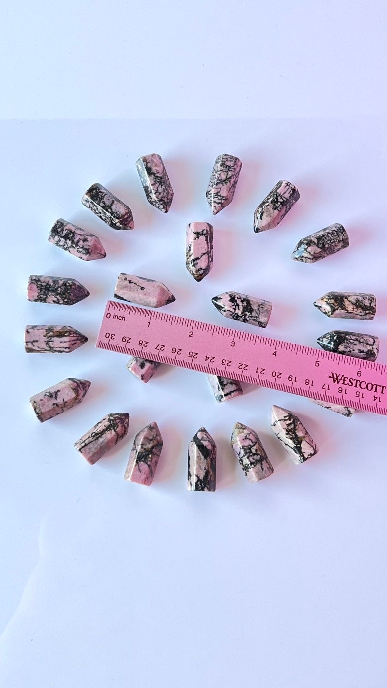 Colorful Rhodonite mini points 1 1/2 inch tall towers with a great pink color and black manganese throughout, Small and subtle crystals.
