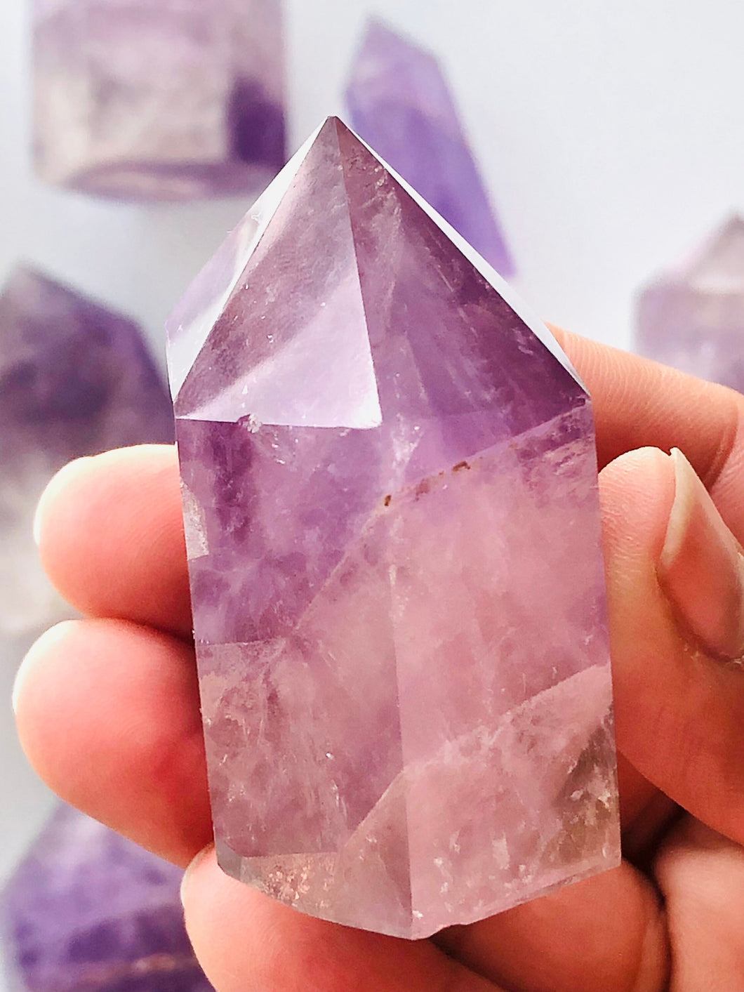 Beautiful 2 1/2 inch Amethyst Point with inclusions weighs 5 oz. Short but stocky tower with interesting subtle pattern