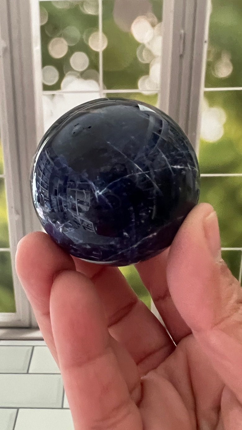 Stunning 2 inch Sodalite Sphere with deep royal blue color with a white calcite pattern, wooden stand included.