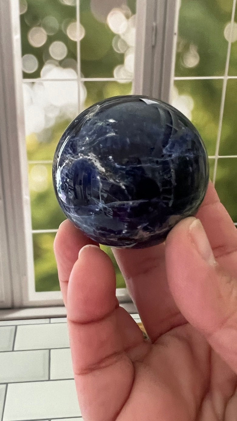 Stunning 2 inch Sodalite Sphere with deep royal blue color with a white calcite pattern, wooden stand included.