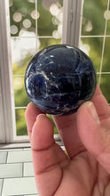 Load image into Gallery viewer, Stunning 2 inch Sodalite Sphere with deep royal blue color with a white calcite pattern, wooden stand included.
