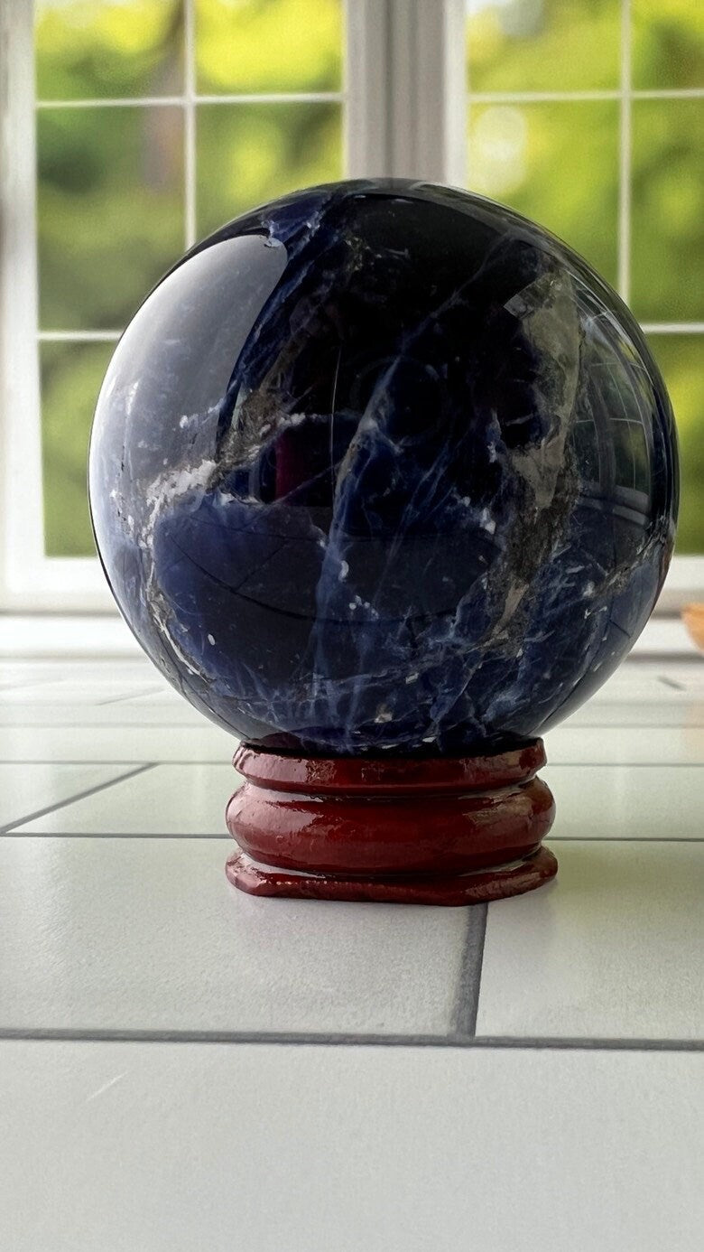Stunning 2 inch Sodalite Sphere with deep royal blue color with a white calcite pattern, wooden stand included.