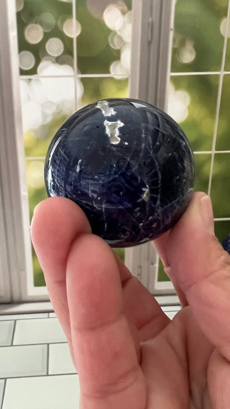 Stunning 2 inch Sodalite Sphere with deep royal blue color with a white calcite pattern, wooden stand included.