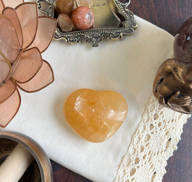 Beautiful Honey Calcite Heart Carving with rainbow inclusions 2 1/2 inches wide 3.5 ounces