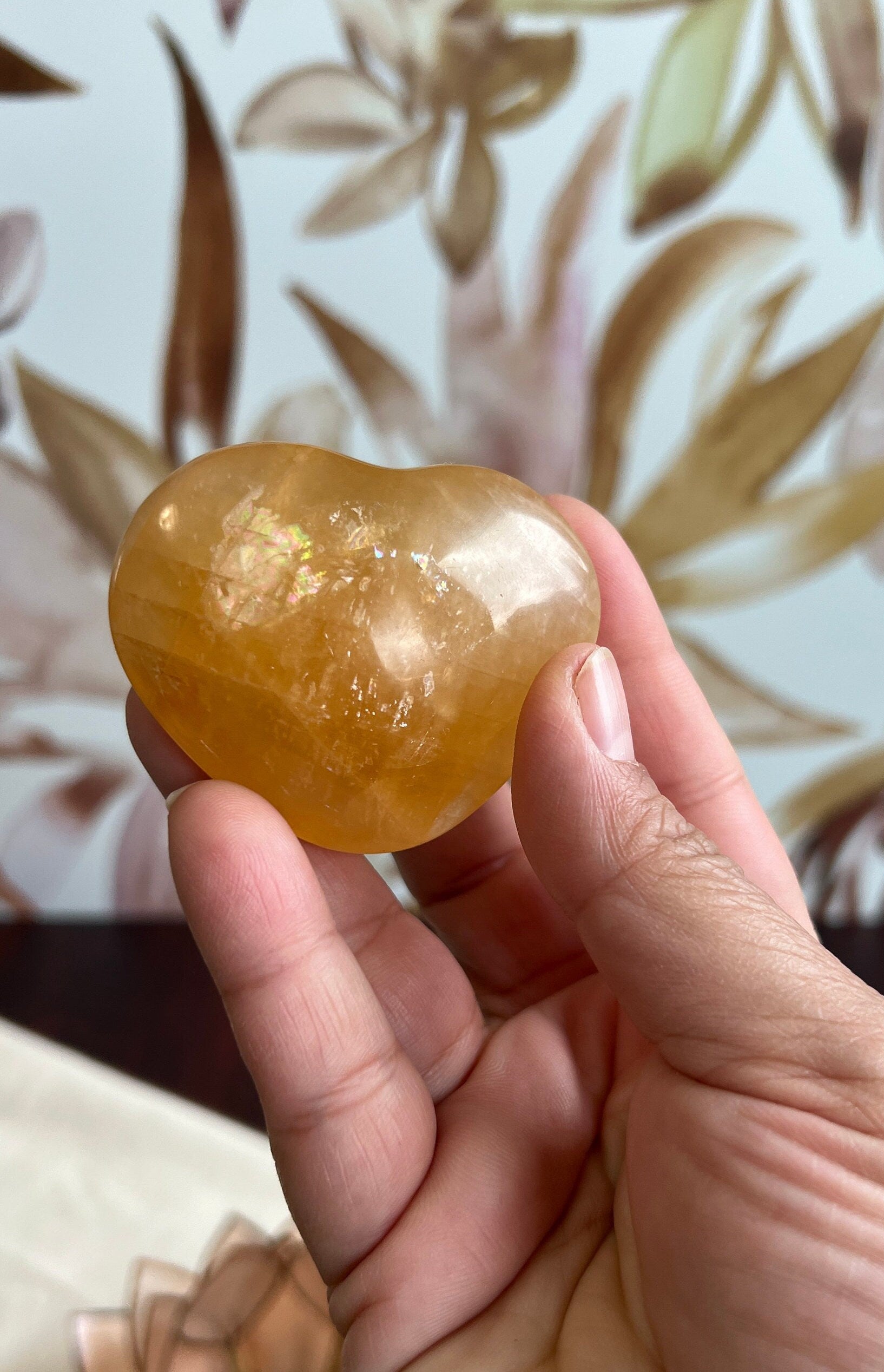 Beautiful Honey Calcite Heart Carving with rainbow inclusions 2 1/2 inches wide 3.5 ounces