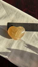 Load image into Gallery viewer, Beautiful Honey Calcite Heart Carving with rainbow inclusions 2 1/4 inches wide 2.8 ounces (HC-Heart2)
