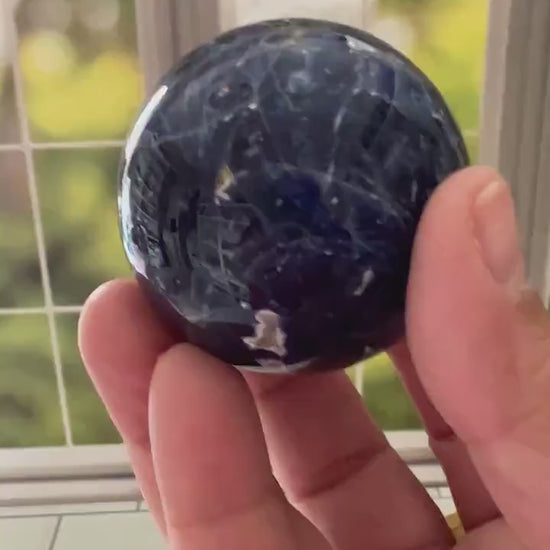 Stunning 2 inch Sodalite Sphere with deep royal blue color with a white calcite pattern, wooden stand included.