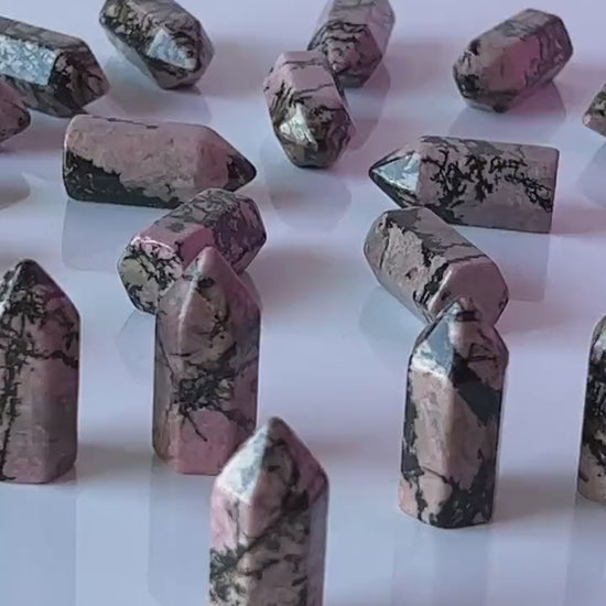 Colorful Rhodonite mini points 1 1/2 inch tall towers with a great pink color and black manganese throughout, Small and subtle crystals.