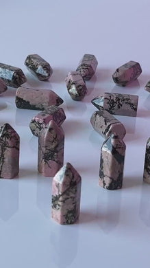 Colorful Rhodonite mini points 1 1/2 inch tall towers with a great pink color and black manganese throughout, Small and subtle crystals.